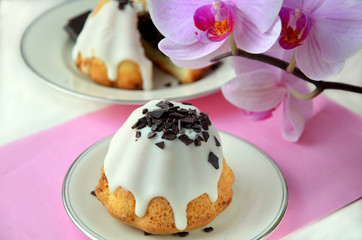 mini cupcake on a plate and pink orchid flowers