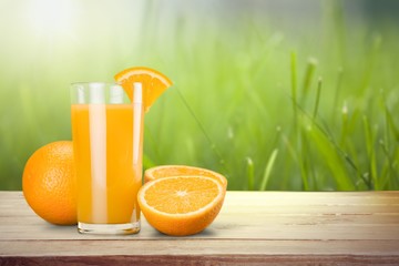 Orange juice in glass and slices of orange fruit