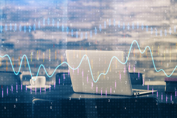 Financial graph colorful drawing and table with computer on background. Multi exposure. Concept of international markets.