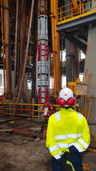 Project engineer supervising works in moonpool onboard of a drillship with telescopic joint at the...