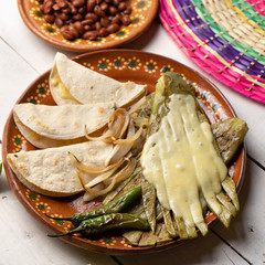 Mexican grilled nopal cactus with quesadillas and serrano chili peppers on white background