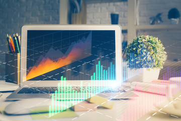 Financial graph colorful drawing and table with computer on background. Double exposure. Concept of international markets.