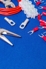 Kit spare parts and tool, red wires for electrical prepared before repair or setting on blue workshop table