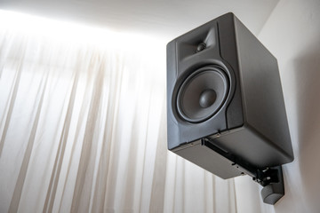black speaker on the wall in the room for sound