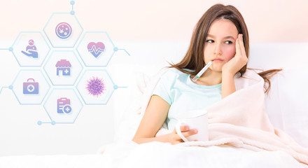 Teenage girl sick with virus with fever stays in bed, measures fever with thermometer