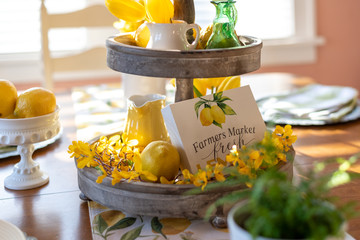 Closeup of tiered tray decorated for Spring on the dining room table