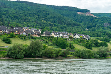 Obraz premium Germany, Rhine Romantic Cruise, a large body of water with a mountain in the background
