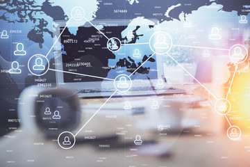 Computer on desktop with social network hologram. Multi exposure. Concept of international people connections.