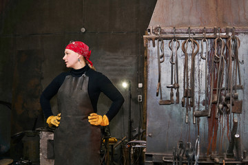 woman blacksmith metal artist in her forge