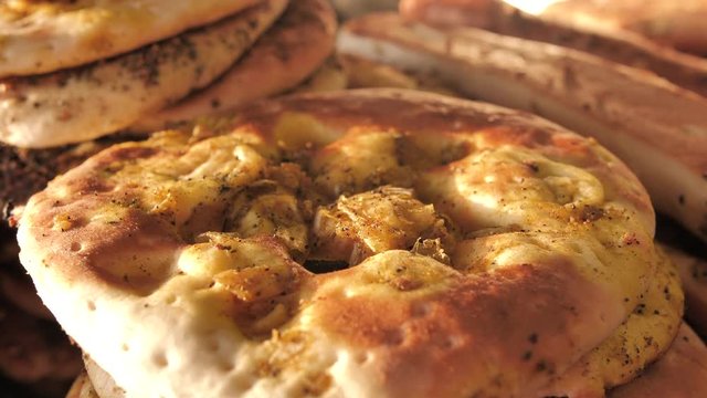 Freashly baked arab flatbreads at Mahane Yehuda Market in Jerusalem. Manakish - Flatbread tooped with cheese. Traditional Arab food.