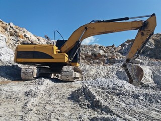 Backhoe is digging for gypsum ore at the mine
