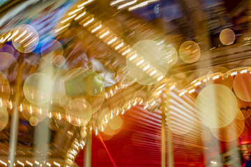 Motion blur of merry-go-round carousel with bokeh nobody