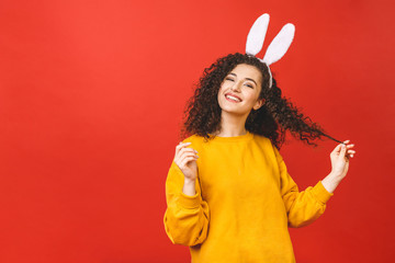 Young caucasian woman wearing cute easter rabbit ears over red isolated background while smiling confident and happy.