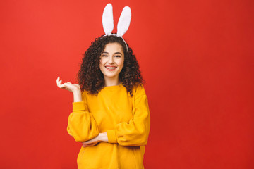 Young caucasian woman wearing cute easter rabbit ears over red isolated background while smiling confident and happy.