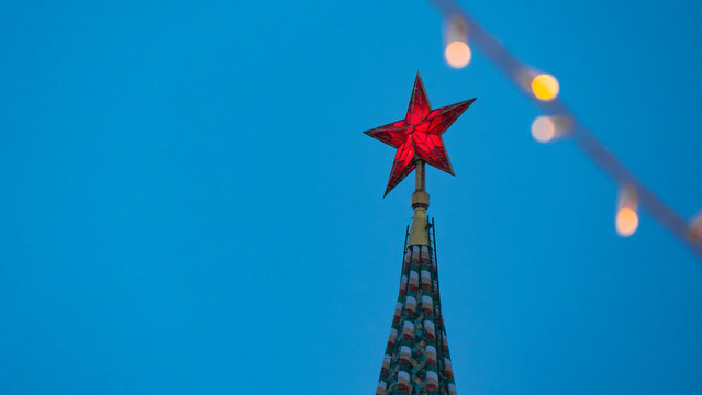 Red star on the tower of the Kremlin. The Spasskaya Tower. Moscow Kremlin, city center, center of Russia. Festive lights and decorations for the new year.