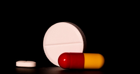 Pills. Medical pills and capsules. Isolated on a black background(alpha channel). A fast-dissolving, effervescent tablet, allergy pill, antibiotics. Virus(Viral) and flu Diseases in Winter.