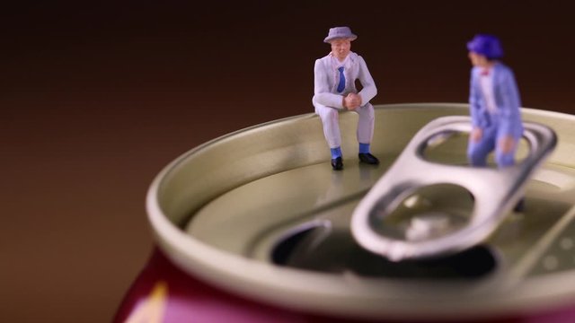 開いた缶ビールと会話する二人の男　右へ水平移動