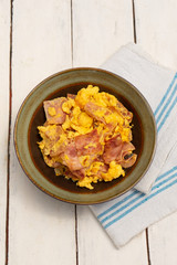 Eggs with ham for breakfast on white background