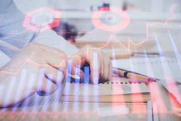 Multi exposure closeup hands with stock market forex graph.