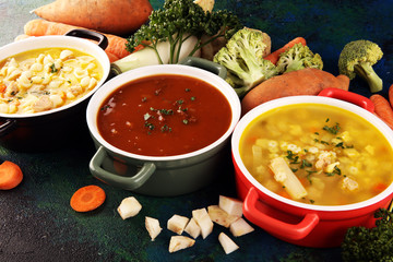 Set of soups from worldwide cuisines, healthy food. Broth with noodles, beef soup and broth with marrow dumplings. All soups with healthy vegetables on table