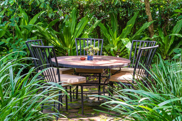 Obraz premium Empty restaurant terrace in tropical garden with tables and chairs. Tanzania, Africa
