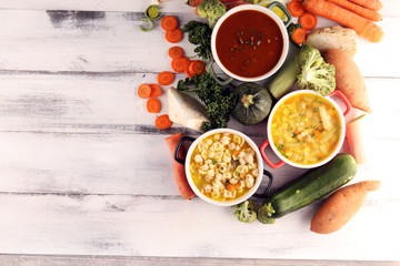 Set of soups from worldwide cuisines, healthy food. Broth with noodles, beef soup and broth with marrow dumplings. All soups with healthy vegetables on table