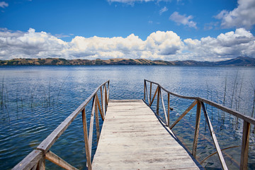 Fototapeta na wymiar Inspiring view of blue sky and water from a dock. Tota's lake, Colombia