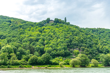 Fototapeta na wymiar Germany, Rhine Romantic Cruise, a large body of water surrounded by trees