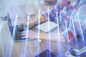 Multi exposure of forex graph with man working on computer on background. Concept of market analysis.