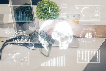 Multi exposure of graph with man typing on computer in office on background. Concept of hard work....