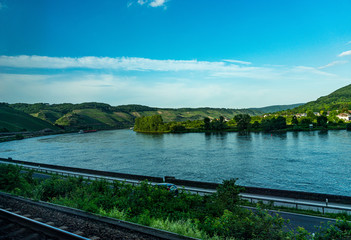 Germany, Hiking Frankfurt Outskirts, a train traveling down train tracks next to a body of water