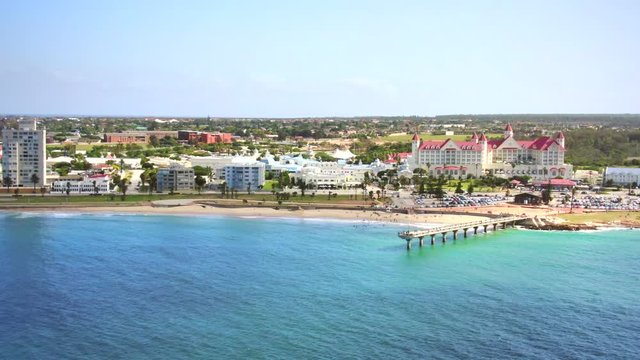Shark Rock Pier and Hobie Beach in Summerstrand, Port Elizabeth. Smooth aerial pull back movement reveals wide beachfront landscape