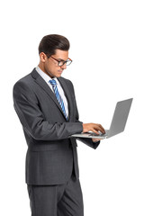 Handsome businessman with laptop on white background