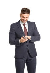 Handsome businessman with mobile phone on white background