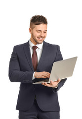 Handsome businessman with laptop on white background