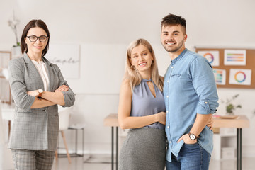 Fototapeta premium Female interior designer with couple in office