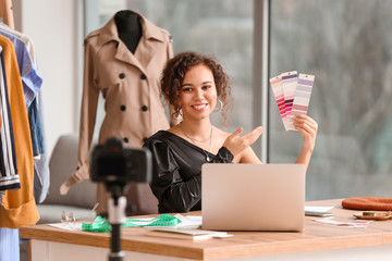 Portrait of female clothes stylist in office