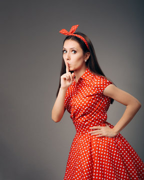 Retro Girl in Vintage Dress with Finger on Lips