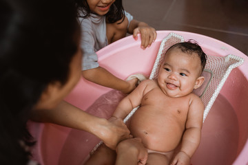 adorable baby having bath, cute baby smiling when take a bath