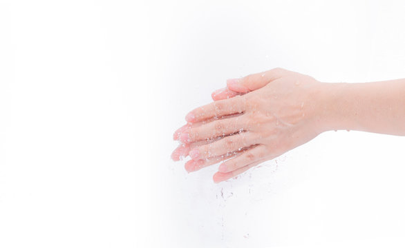 Woman washing hand with water isolated on white background. Good personal hygiene concept. First step to clean dirty hands for prevent flu and coronavirus. Adult woman hand soak and wet with water.