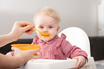 Mother Feeding Baby With Spoon