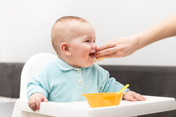 Mother Cleaning Mouth Of Hungry Baby