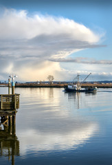 Fraser River Seiner and Cloud. A seine boat travels up the Fraser River. Storm clouds loom in the background.