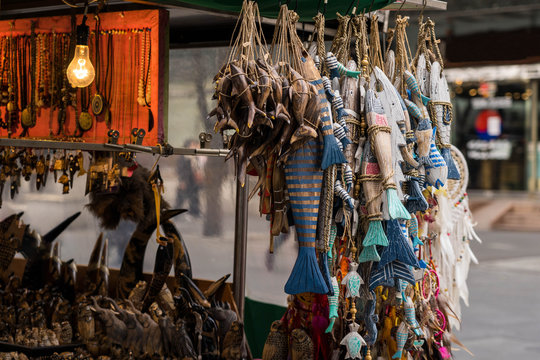 Fish and animal shaped wood craft decorations hanging on a stall in South Korea.