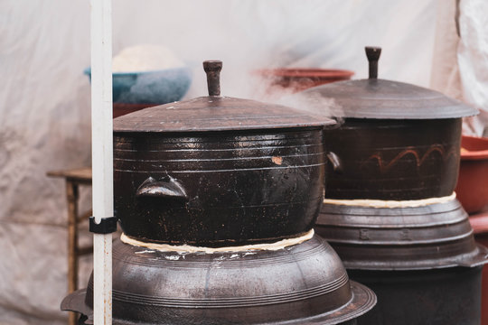 Close up image of large Korean traditional ceramic rice cooker with smoke coming out. Korean stone pot.