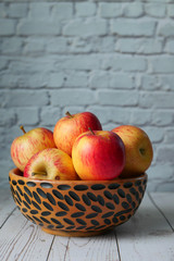 fresh red apple with wooden bowl, close sup 