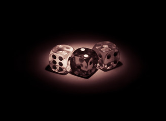 Isolated dices shinning in the dark by soft light