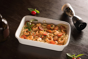 Pasta with shrimp and cherry tomatoes, seasoned with basil and pepper