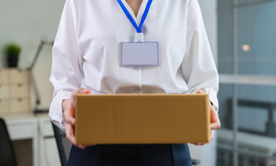 Employee holding packing box in office delivery to customer.