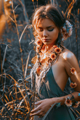 close up portrait of young and tender woman on a feild at sunset